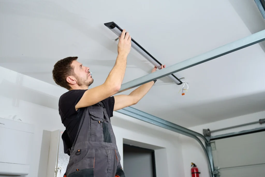 man installs lighting in industrial garage setting 2026 03 26 23 59 45 utc